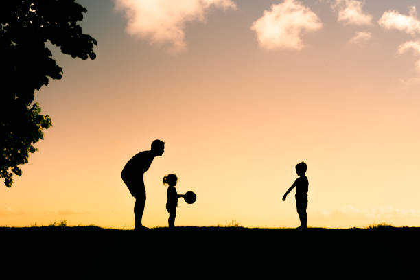 istock Father playing with his children in a beach park. 1424123431