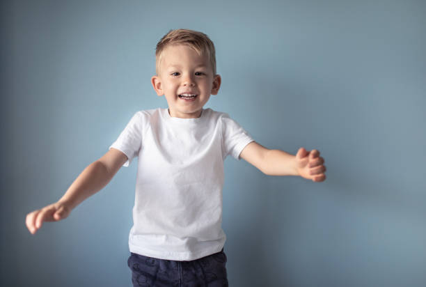 istock Happy boy jumping on the bed. 1424123820