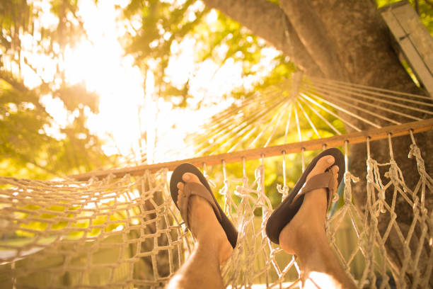 Person's feet relaxing in a hammock.
