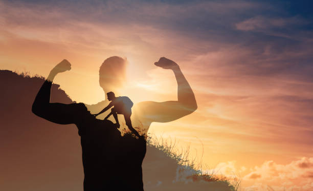 istock Strong young man climbing up a mountain. 1424124401