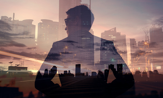 Businessman in the city. Multiple exposure image.