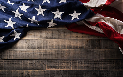 Happy Veterans Day concept. American flags against dark wooden background. November 11.
