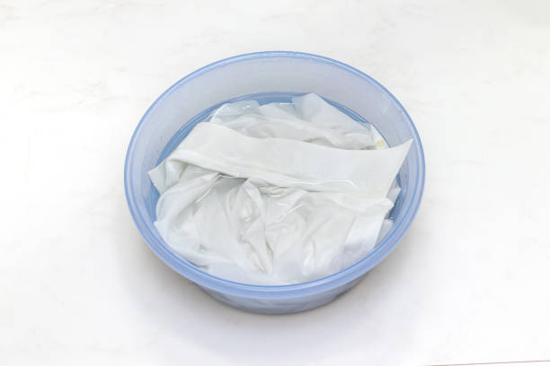 istock White clothes soaked in water in a basin 1424132183