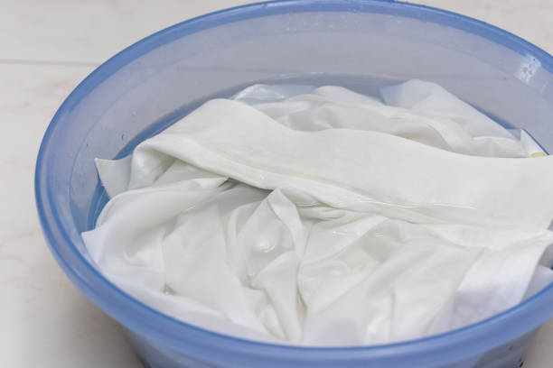 istock White clothes soaked in water in a basin 1424132184