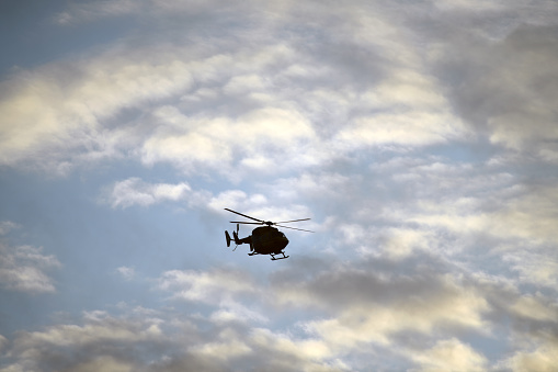 Silhouette of a rescue helicopter about to land at hospital