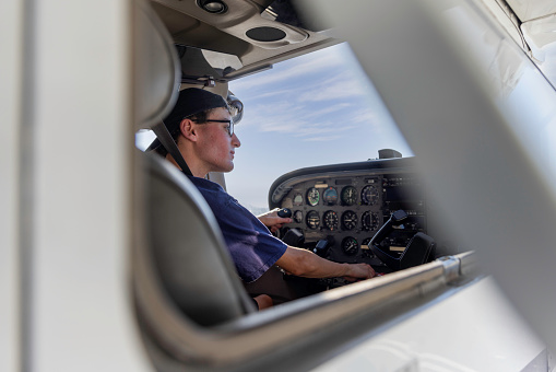 High quality stock photos of a young certified pilot performing safety checks and inspections on a small engine airplane in Calfornia.