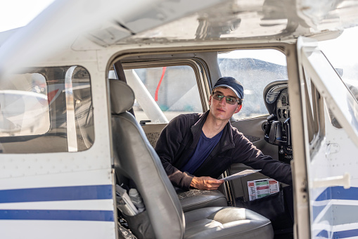 High quality stock photos of a young certified pilot performing safety checks and inspections on a small engine airplane in Calfornia.