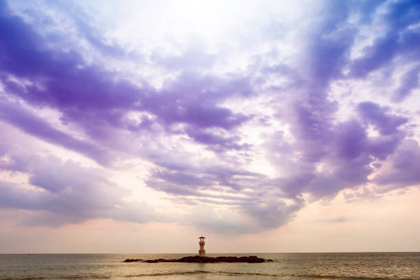 Cloudy sky at the beach, light house on the rock in cloudy day with evening light
