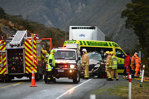 Arthur's PAss, New Zealand, September 5, 2022: Emergency teams respond to a single car accident after the driver lost control on black ice on State Highway 73 while crossing the Southern Alps. Grainy image shot in poor morning light.