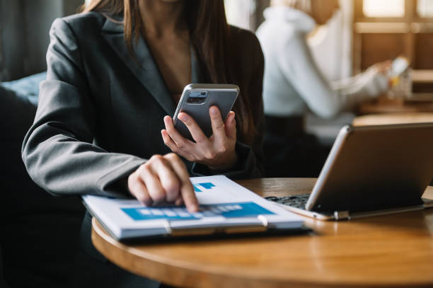 istock Confident businesswoman working on laptop and tablet 1424150458