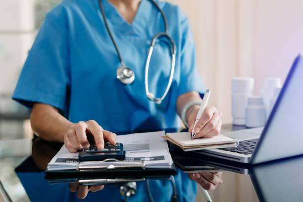 istock Medical technology concept. Doctor working with mobile phone and stethoscope and digital tablet laptop in modern office at hospital 1424150492