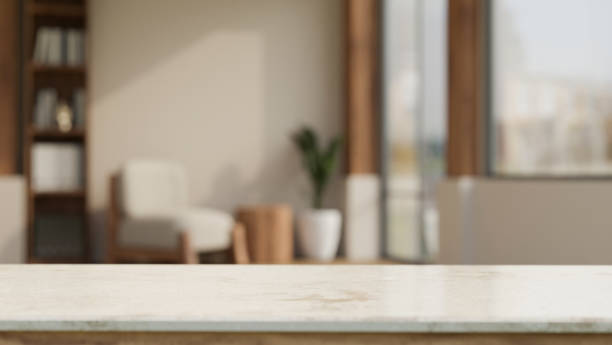 istock Empty white tabletop over blurred modern comfortable living room in the background 1424152382