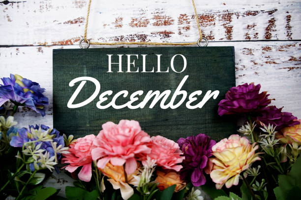 istock Hello December typography text decorate with flower on wooden background 1424160730