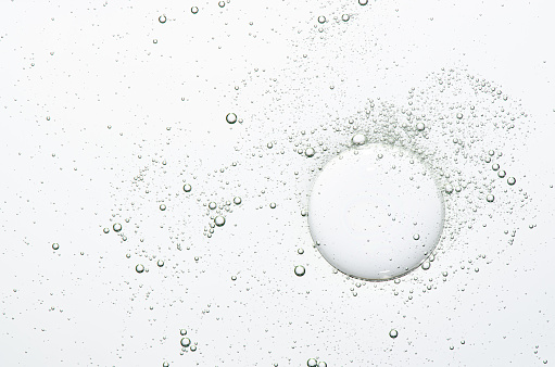 The texture of a cosmetic serum with bubbles in closeup. Macrophotography.