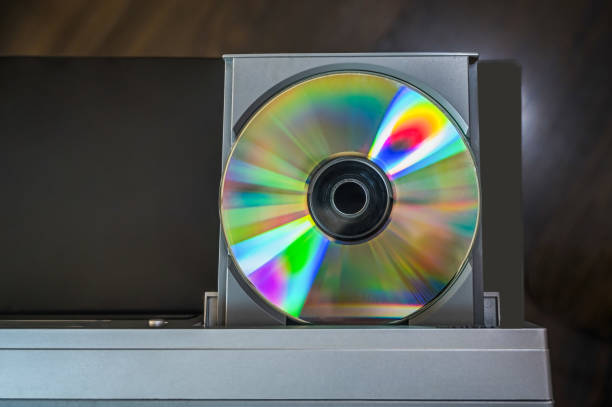 istock close-up vintage cd player with cd. DVD inserting to video player. 1424163902