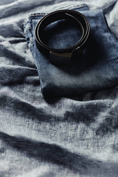 istock Jeans trousers on blue background. Copy space. 1424164402