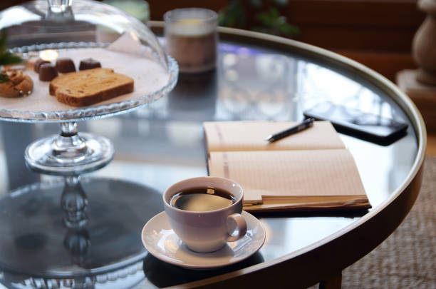 Smartphone and notepad with pen placed on table in home