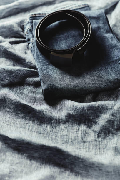 istock Jeans trousers on blue background. Copy space. 1424168697
