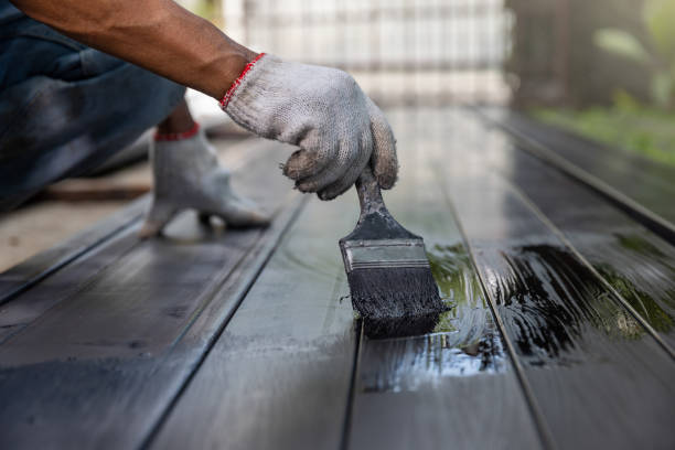 istock Worker painting steel post in construction site. 1424170307