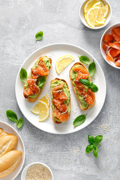 istock Toasts with salted salmon and avocado guacamole, top view 1424171850