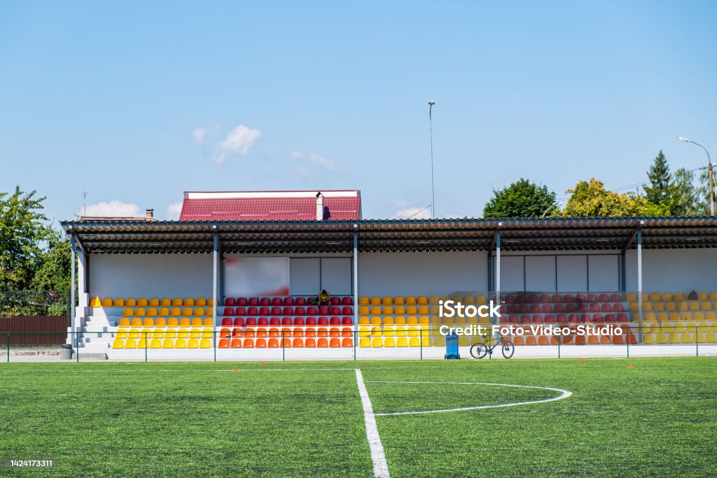 Many yellow and red seats in a football stadium. Championship, football, places for spectators Many yellow and red seats in a football stadium. Championship, football, places for spectators. A-Line Stock Photo