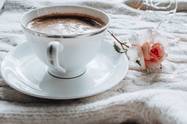 istock White cup with black coffee and tea rose on a white plaid 1424176919