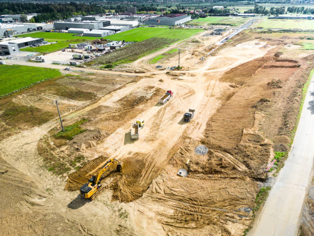 istock Aerial view of a large soil construction site with excavators loading dirt on dump trucks 1424179289