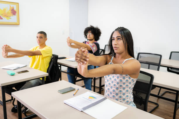 istock Young people in the classroom performing stretching 1424180601