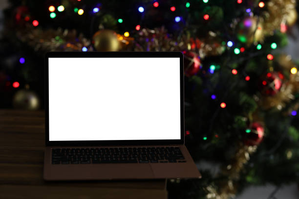 istock Open laptop standing on table near New Year tree 1424182915