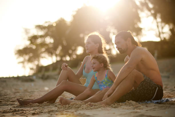 istock Family Relaxing on Sea Beach 1424186420