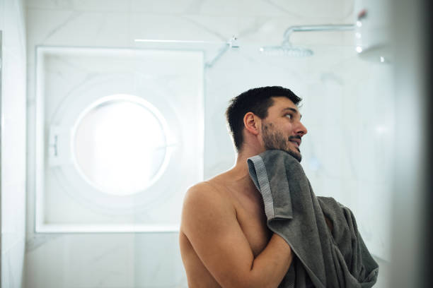 istock Handsome Man Drying his Face with a Towel in the Morning 1424187979