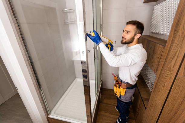 istock Young plumber fixing shower cabin 1424190091