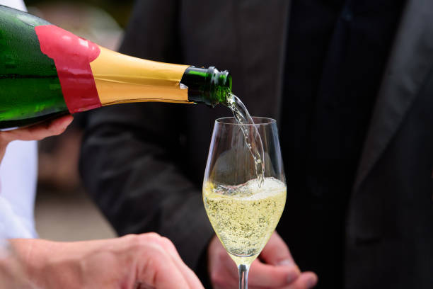 istock pooring champagne into a champagne flute 1424192914