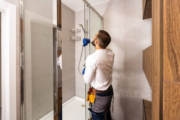 istock Plumber installing a shower cabin in bathroom 1424195041