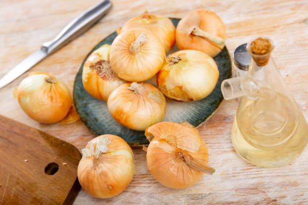 istock Image of whole onion bulbs on a wooden table 1424196838