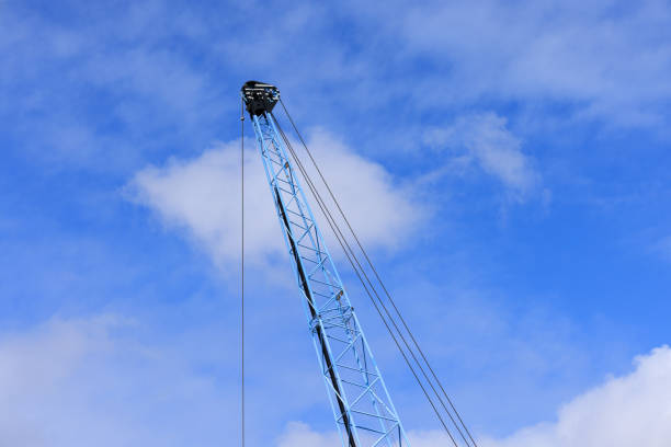 istock Part of a large crane against a cloudy sky 1424197190
