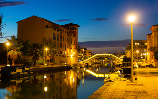 French town of Frejus overlooking embankment and marina at dusk