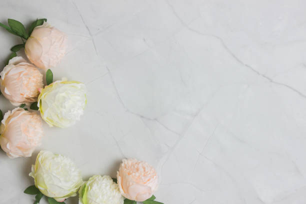 istock White and pink roses over the black marble background with copy space. 1424198572