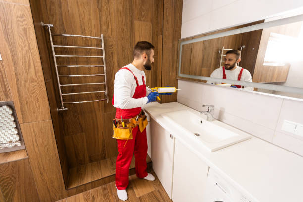 istock Professional plumber with plunger and instruments near sink. 1424200011