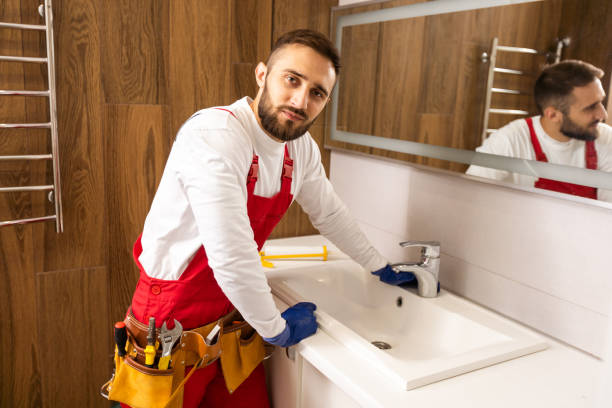 istock Professional plumber with plunger and instruments near sink. 1424202223
