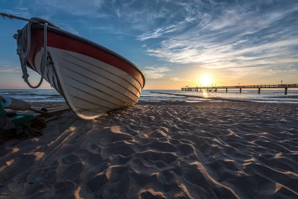 Fishing boat on beach during morning stock photo
