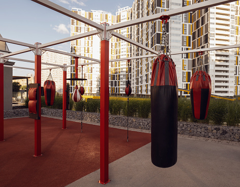 View of the sports boxing ground near the beautiful high-rise buildings in the city. Workout city. brown tint