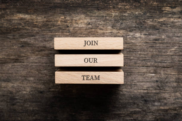 istock Join our team sign written on three wooden pegs 1424203153