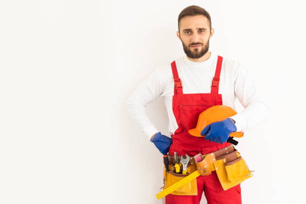istock profession, construction and building - happy smiling male worker or builder over white background 1424203774