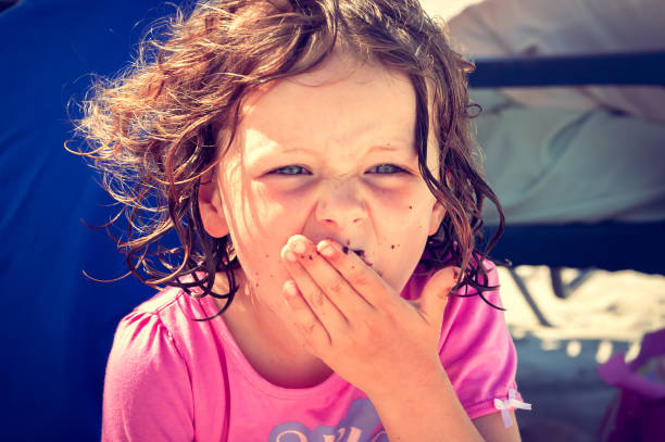 istock Messy eater - toddler eating at a picnic 1424203892