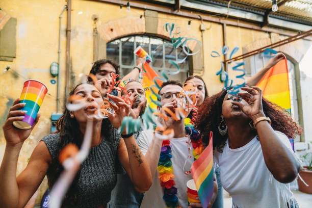 istock People are blowing streamers to the camera during a party 1424205280