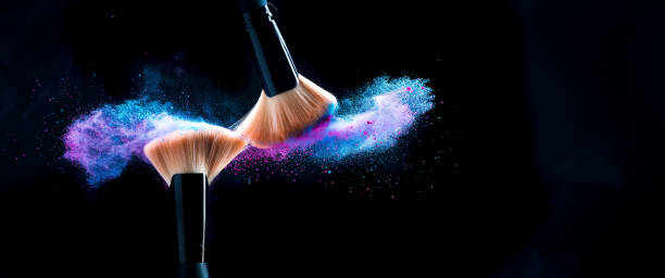 makeup powder scattering from makeup brushes rubbing against each other - powder blue imagens e fotografias de stock