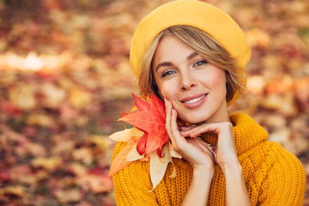 istock Beautiful woman holding a leaf 1424208497