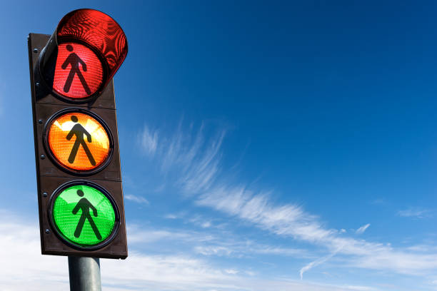 istock Traffic Light - Pedestrian Traffic Sign against a Blue Sky with Clouds 1424211981
