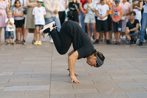 Moscow, Russia- August 14, 2022: Street life of city in sunny summer day. Big audience. People having fun. Breaking, also called breakdancing, b-boying or b-girling, is athletic style of street dance